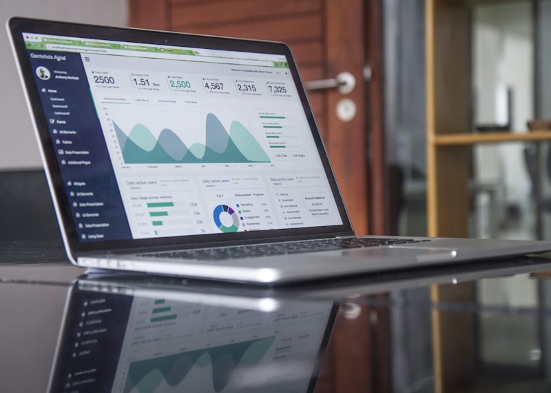 Real estate data analytics displayed on laptop showing market trends and performance