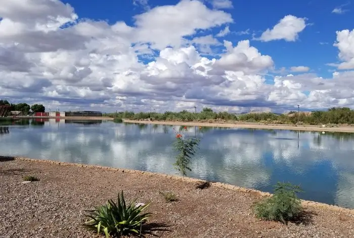 east valley az communities Queen Creek lake with desert landscape and open sky