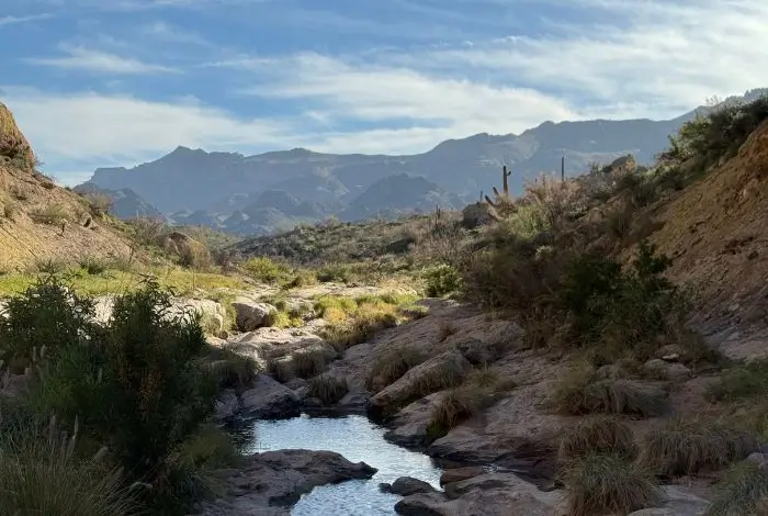 east valley az communities Apache Junction desert trail with mountains and rocky terrain