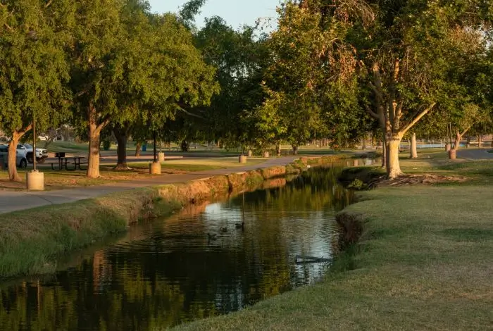 east valley az communities Scottsdale park with canal, trees, and walking path